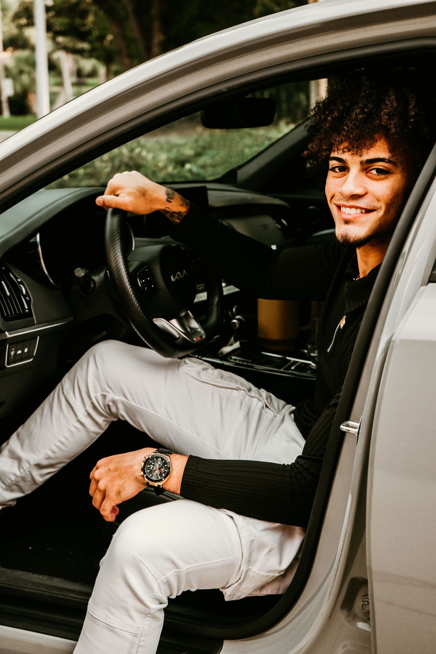 Outdoor Senior Portrait Session at University of Tampa in Tampa, FL; Senior pictures, teen sitting in drivers seat of car