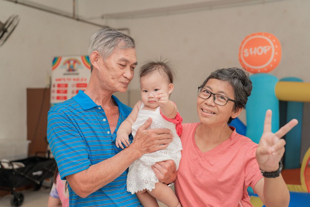 Family gathering shows warm interaction during indoor celebration.