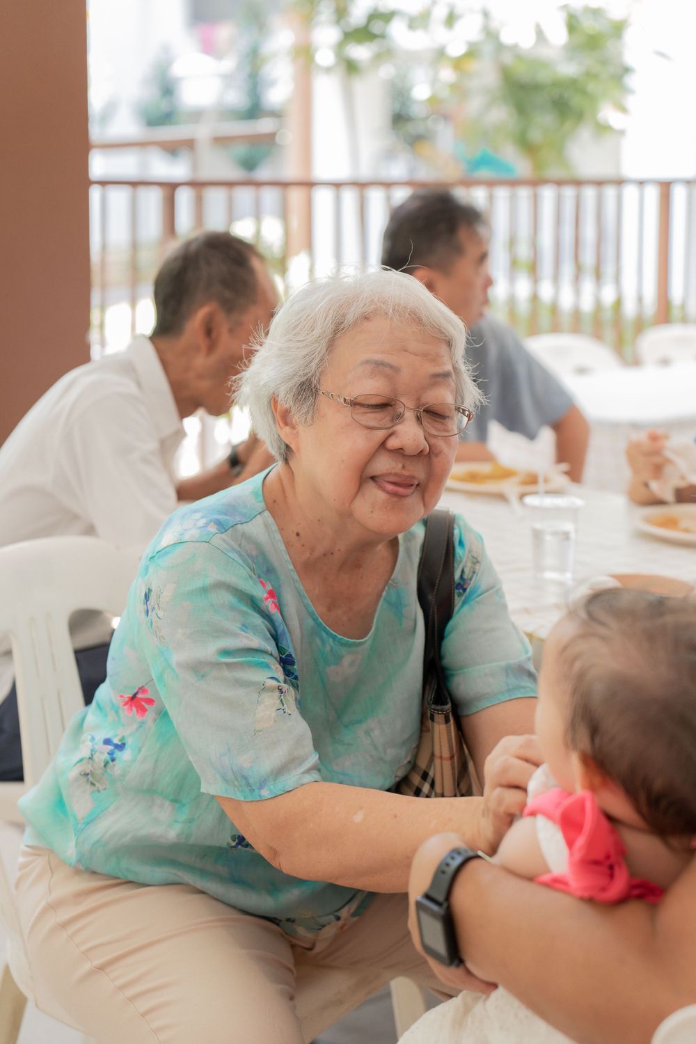 Heartwarming interaction between family members during mealtime gathering.