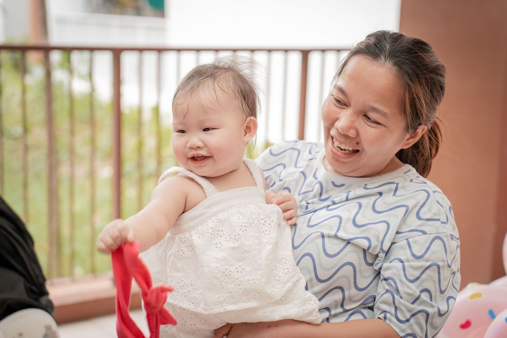 An intimate moment of joy shared between family members at a celebration.