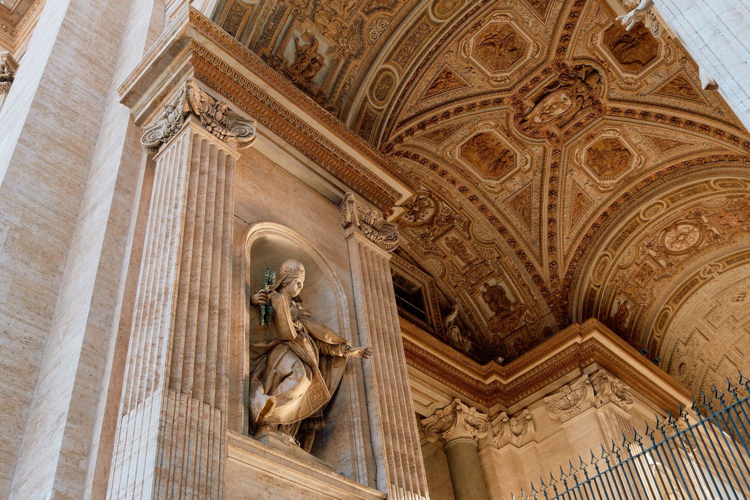 Ornate baroque ceiling and architectural details inside a historic Italian church or palace with detailed sculptures.