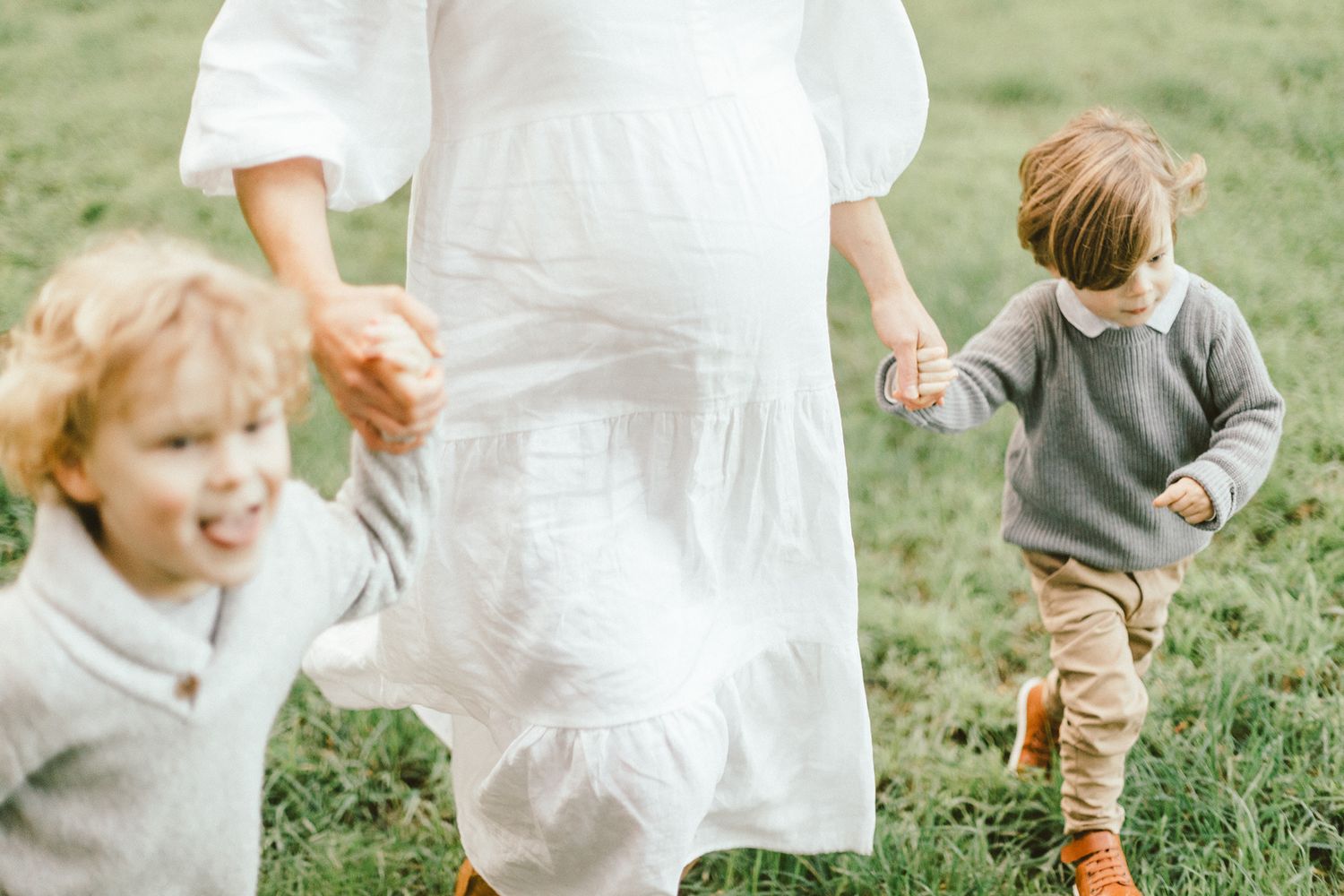 Joyful outdoor family photos capturing candid moments between parents and children.