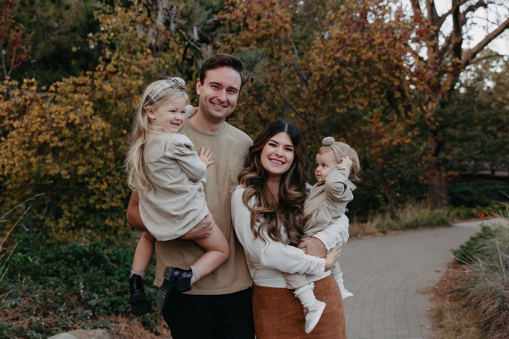 Family photo session in park with autumn colors and natural lighting.
