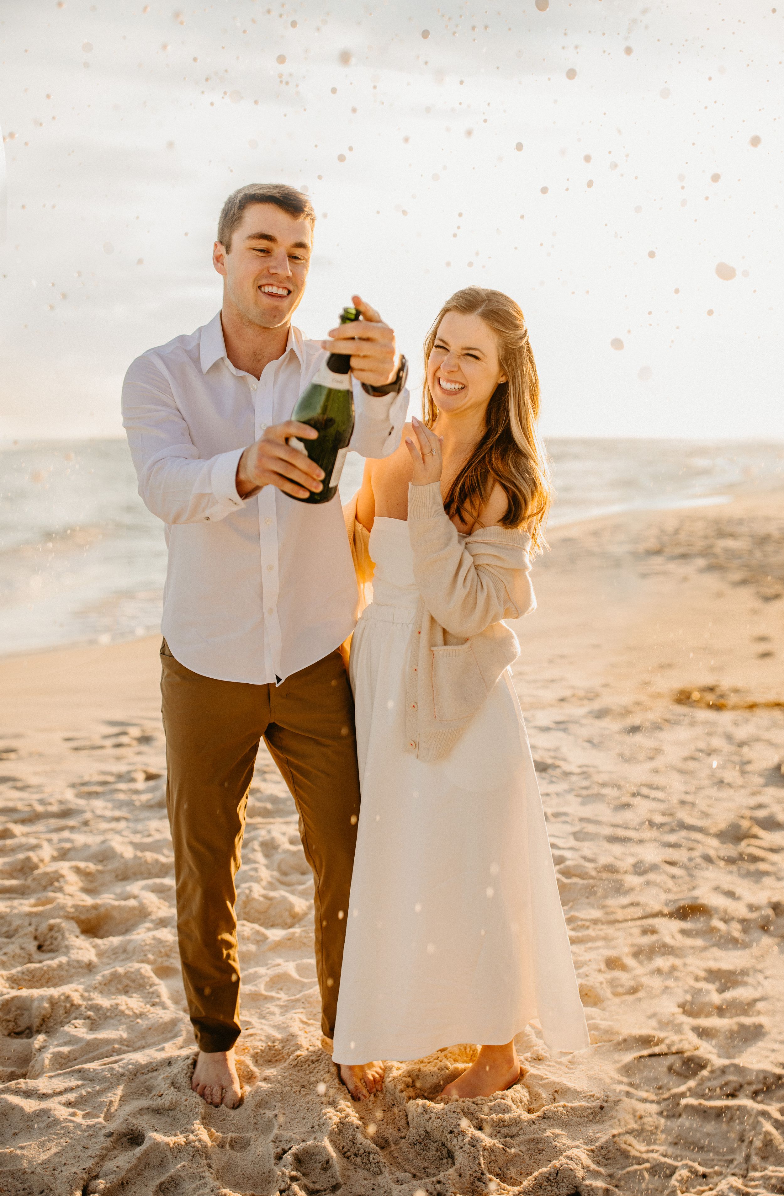 romantic couple wedding photo at sunset champagne spray by Julianne drake photography champagne elope elopement love story