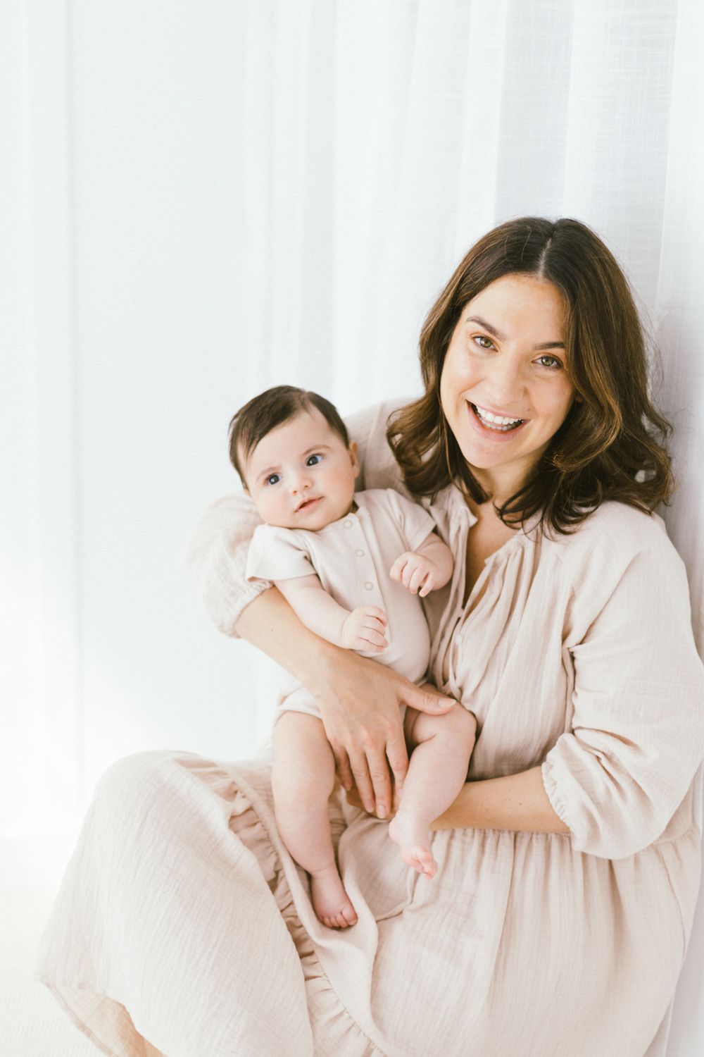 An intimate portrait series showing joyful bonding moments in soft light.
