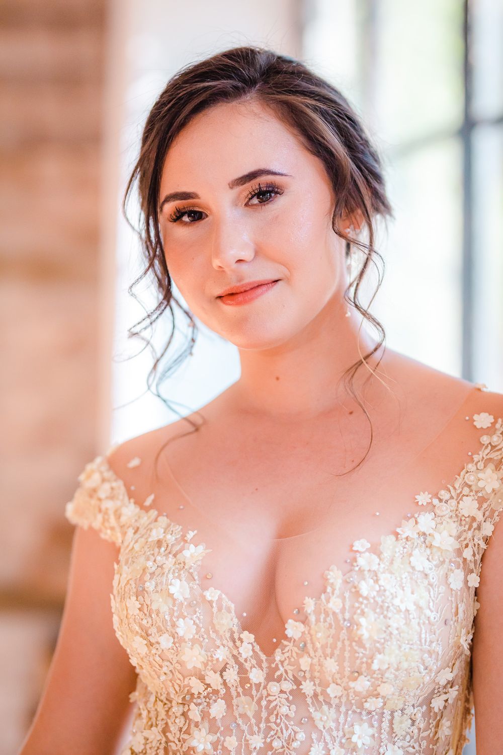 A young woman with dark upstyle hair and olive skin, looking radiant in a beautiful yellow flowery lace dress