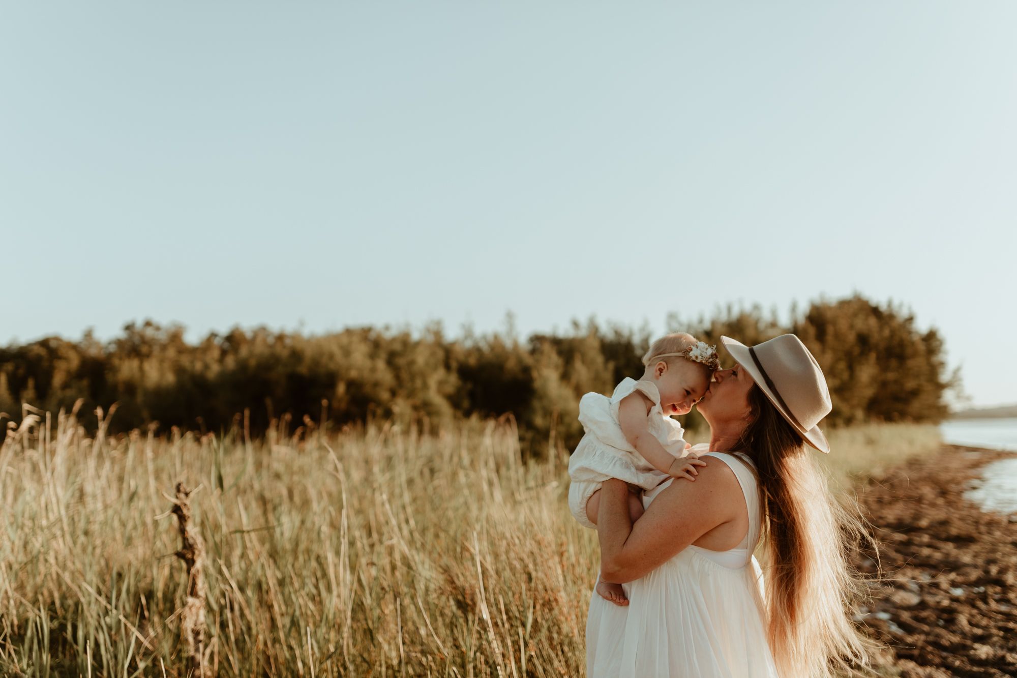 A tender moment between parent and child against a backdrop of golden wheat fields.