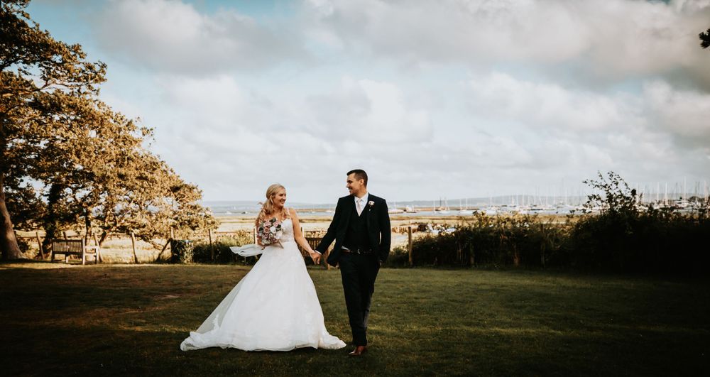 Scenic outdoor wedding photos with rolling hills and dramatic sky at sunset.