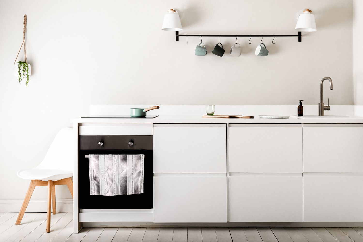 minimal, clean white kitchen with white chair, stylish holiday letting photography