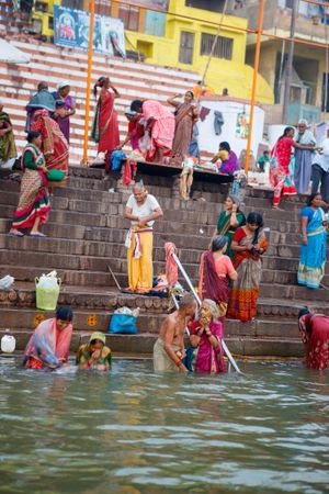 locals bathing in the river ganges on the colourful ghats in Varanasi India