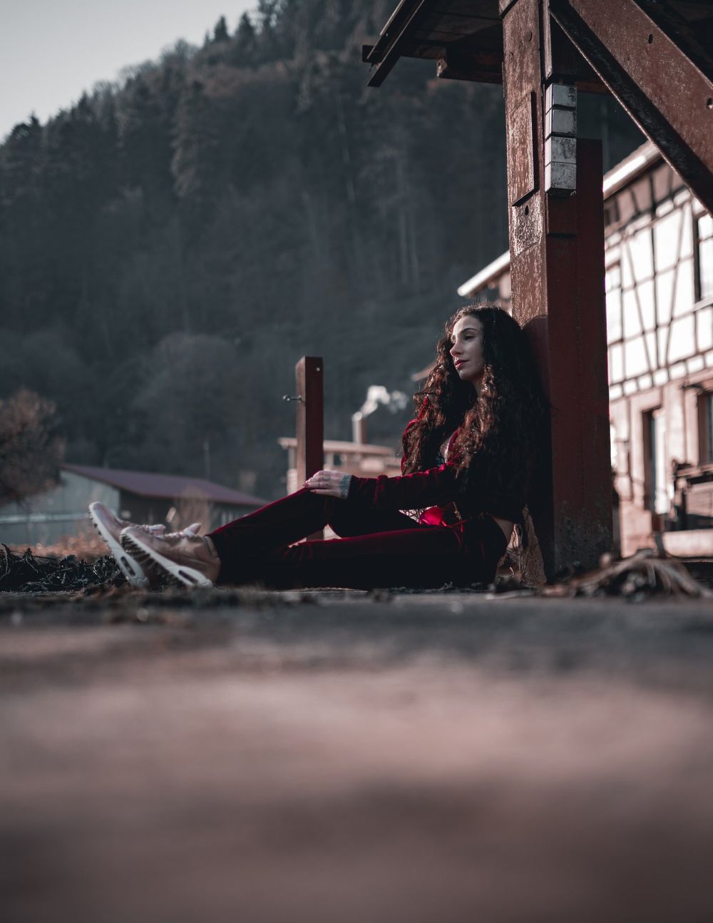 Artistic composition featuring velvet attire against mountainous backdrop and traditional architecture.