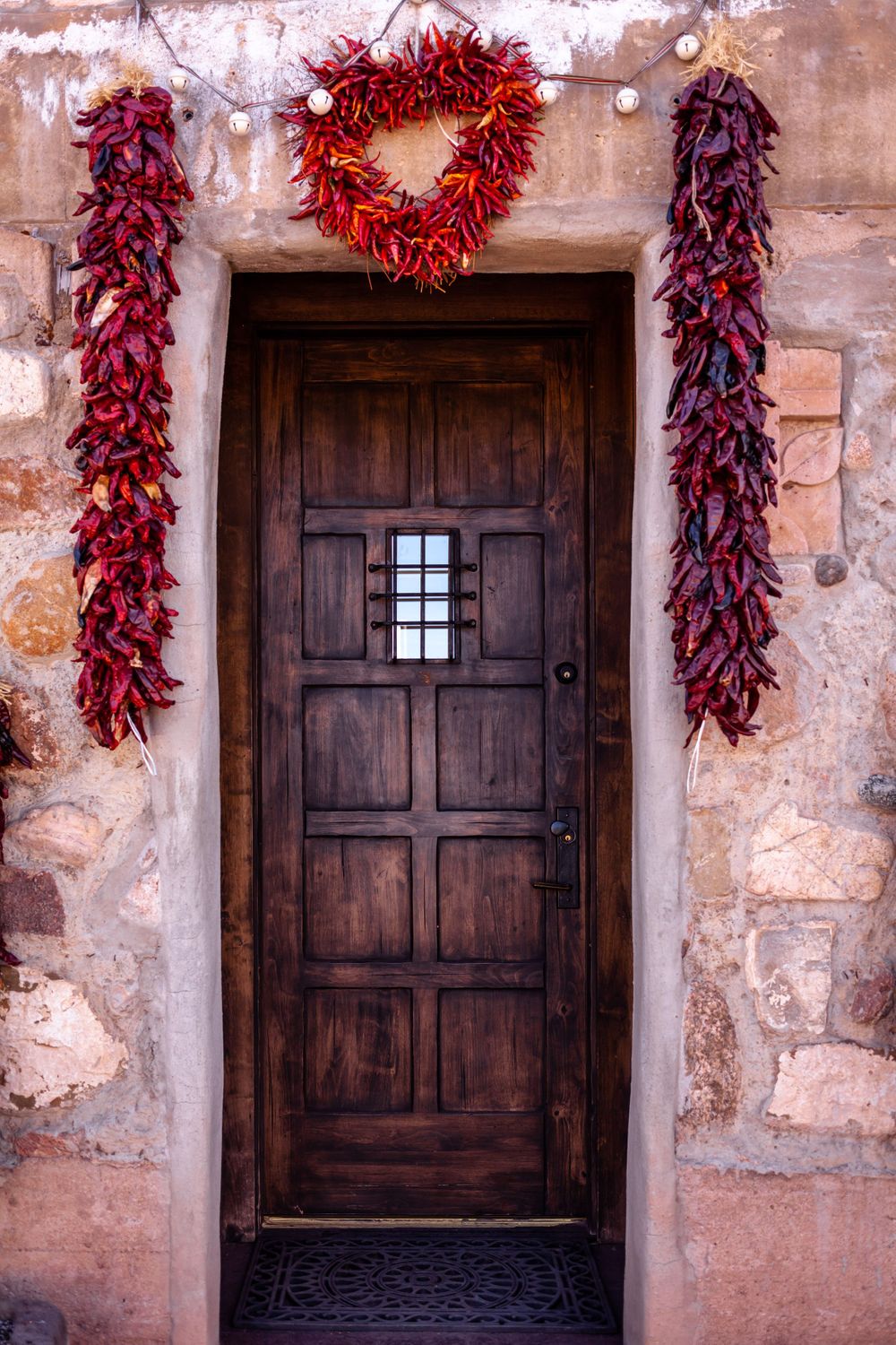 Walnut door and red peppers in Santa Fe, New Mexico