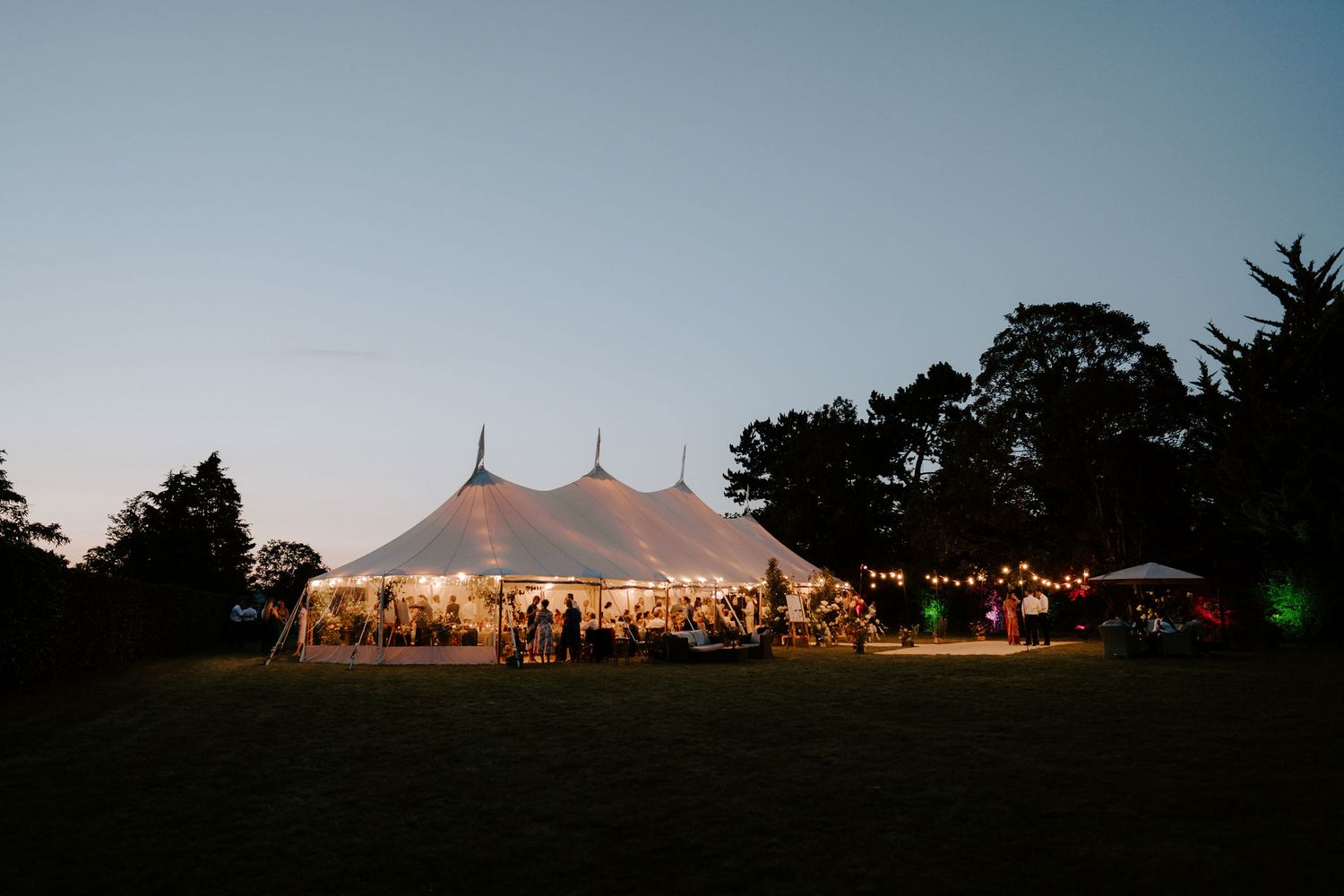 marquee on lawn at dusk at wedding in oxfordshire