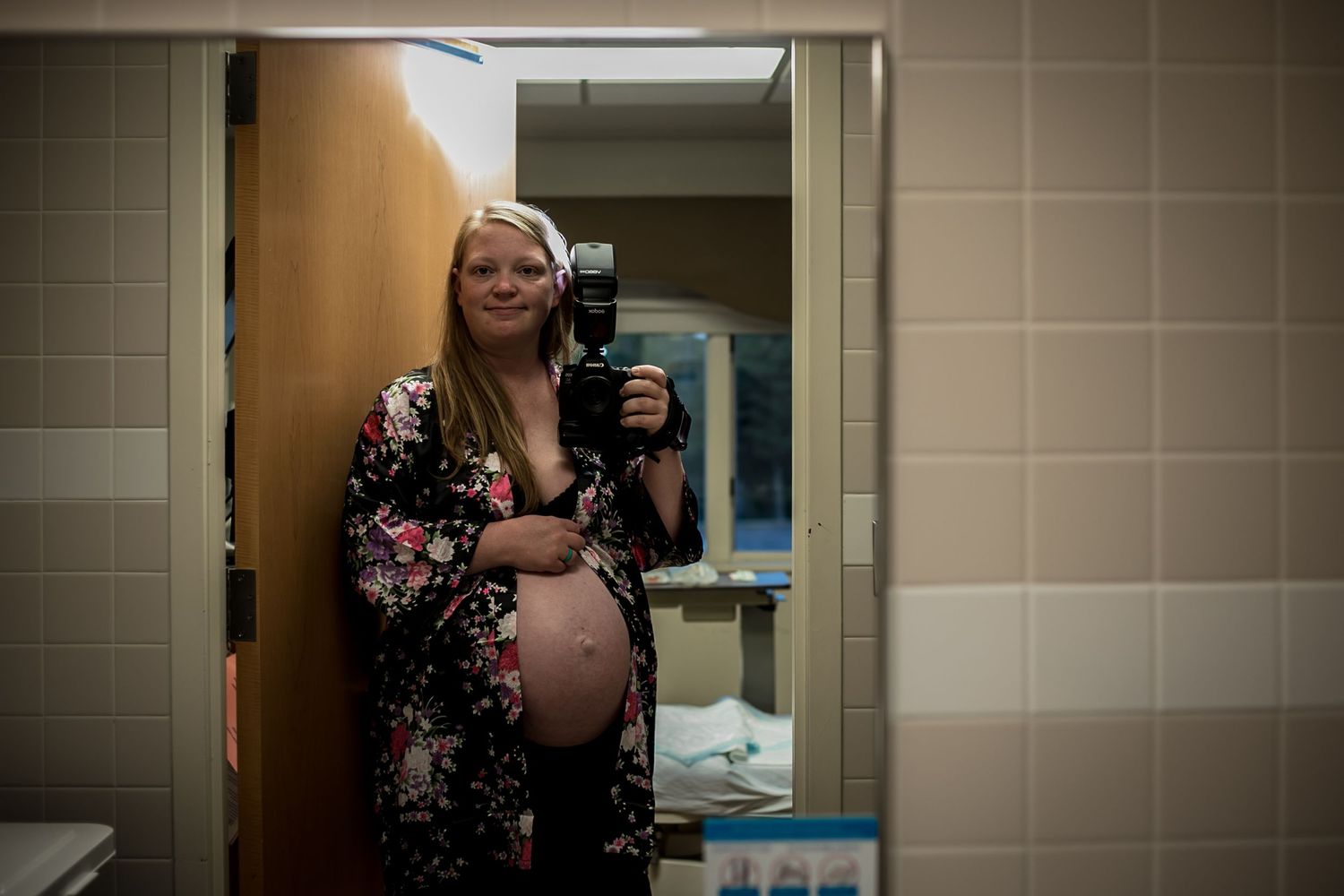 Michelle Criss, Photographer photographing herself in a mirror while in labor at UnityPoint Health in Sioux City, IA.