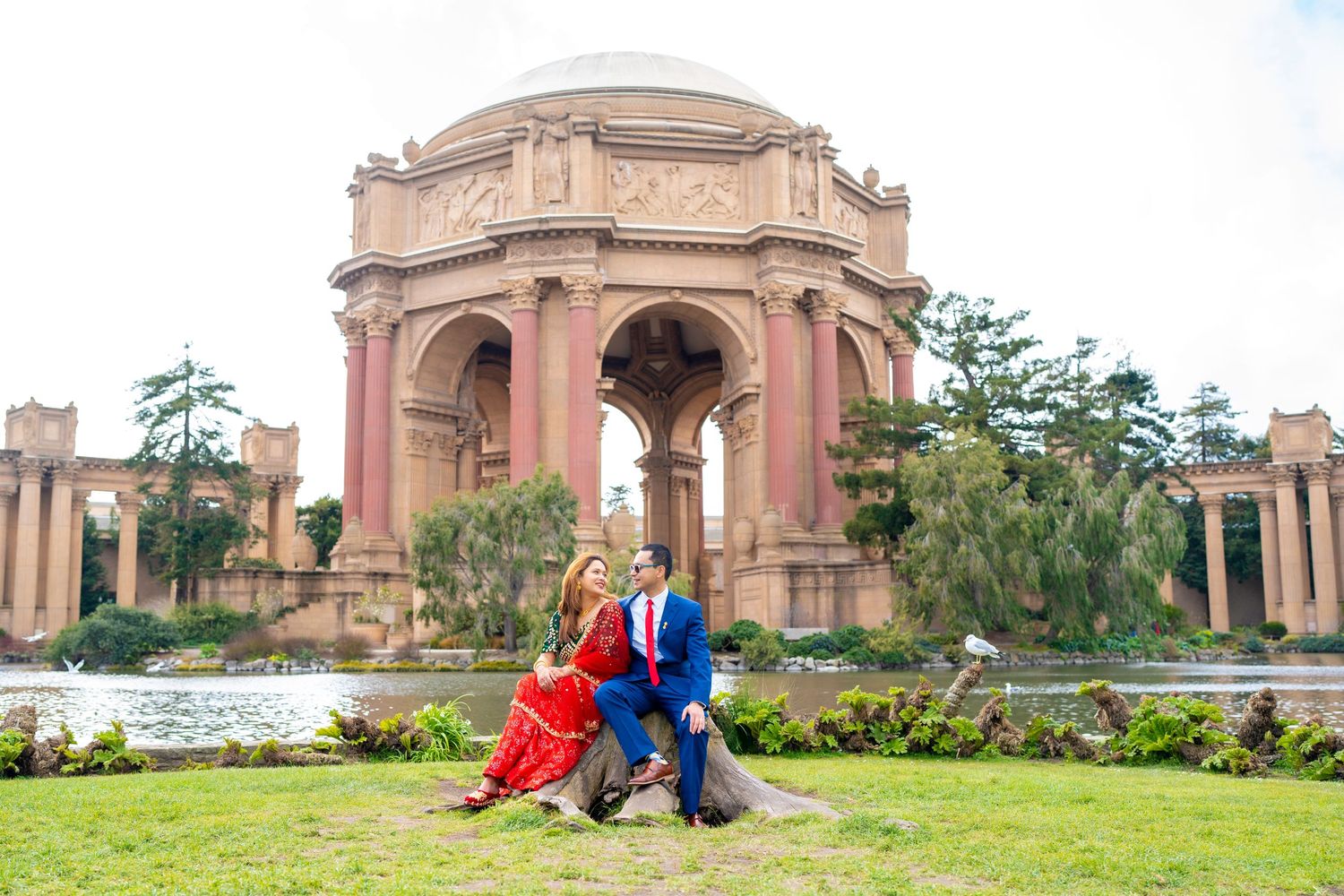 A couple poses in formal wear at the Palace of Fine Arts in San Francisco.