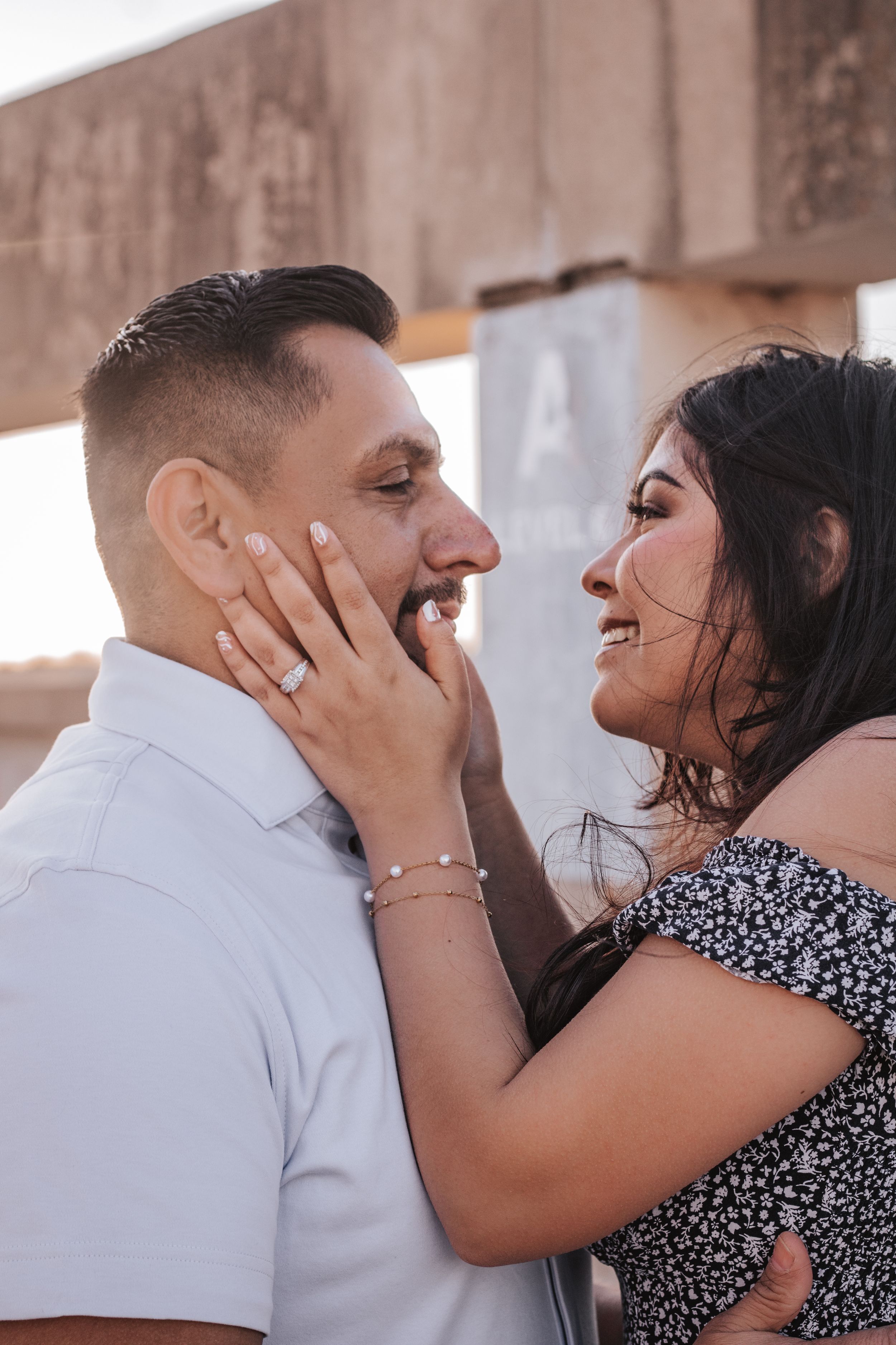 Romantic couple sharing intimate moments in urban setting.