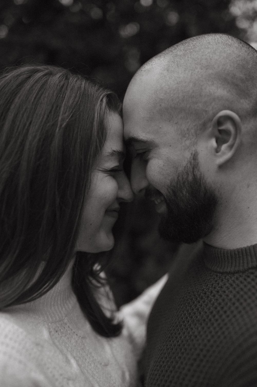 An intimate black and white close-up portrait showing tender affection.