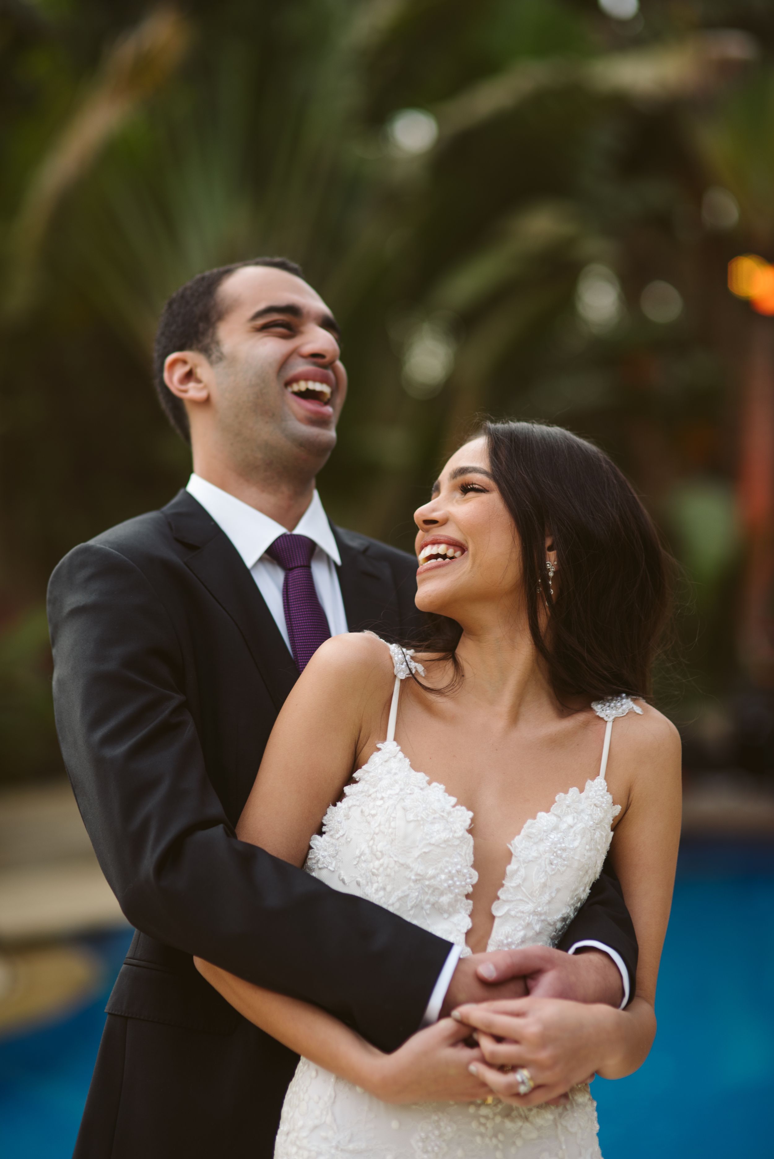 Joyful candid moment captured during outdoor wedding photoshoot.