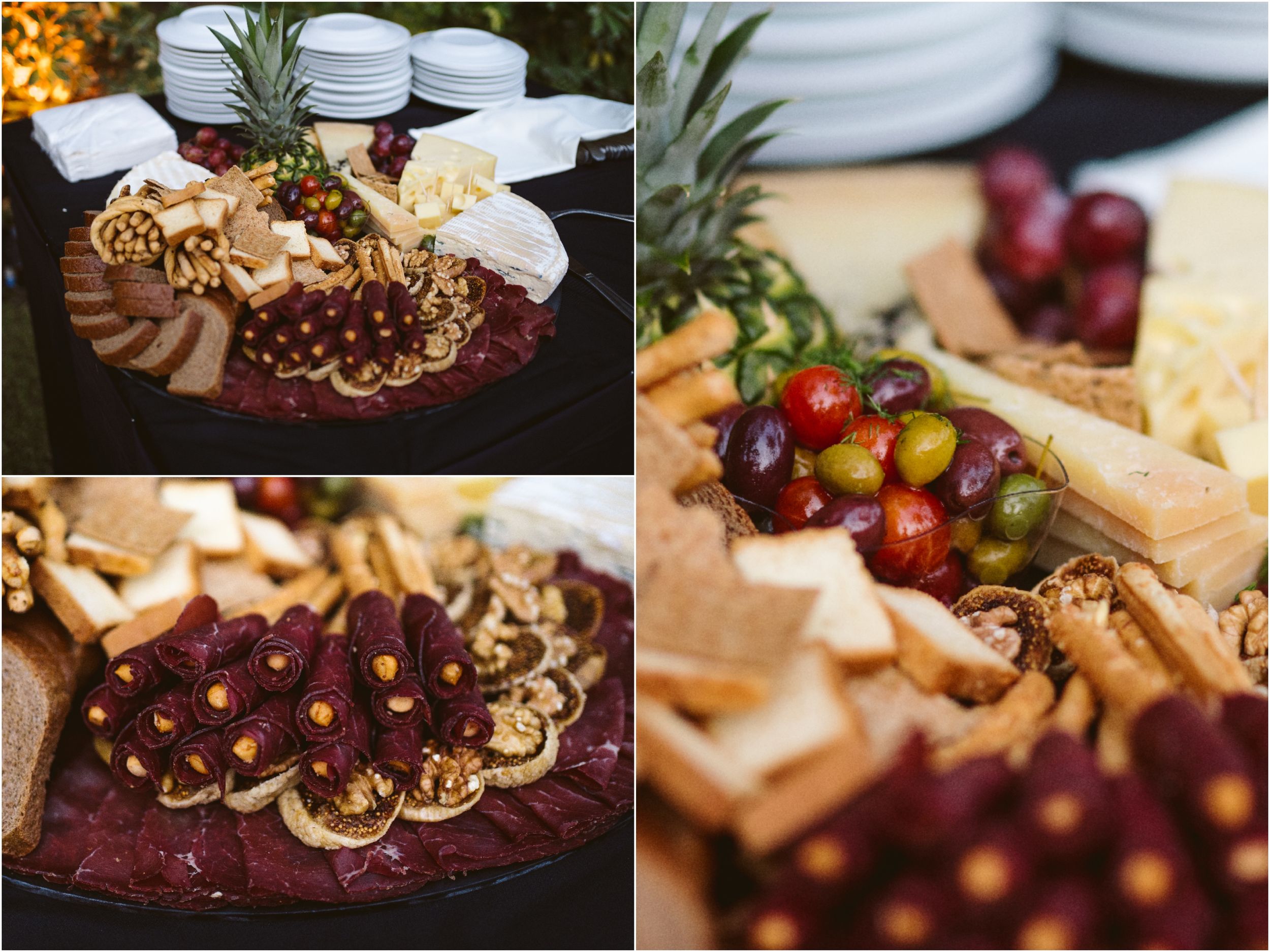 Artfully arranged charcuterie boards with fruits, cheeses and garnishes at an upscale event.
