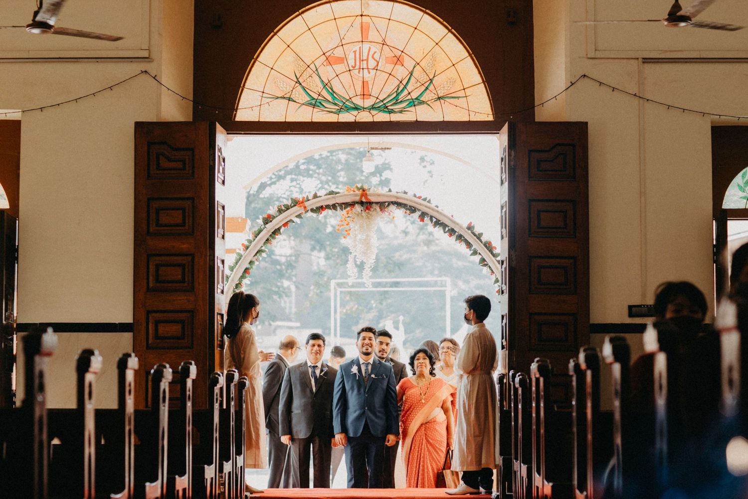 Wedding ceremony in a traditional church with ornate architecture and stained glass windows.