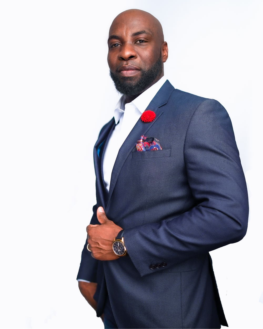 Professional man in navy blue suit with red rose boutonniere on white background.