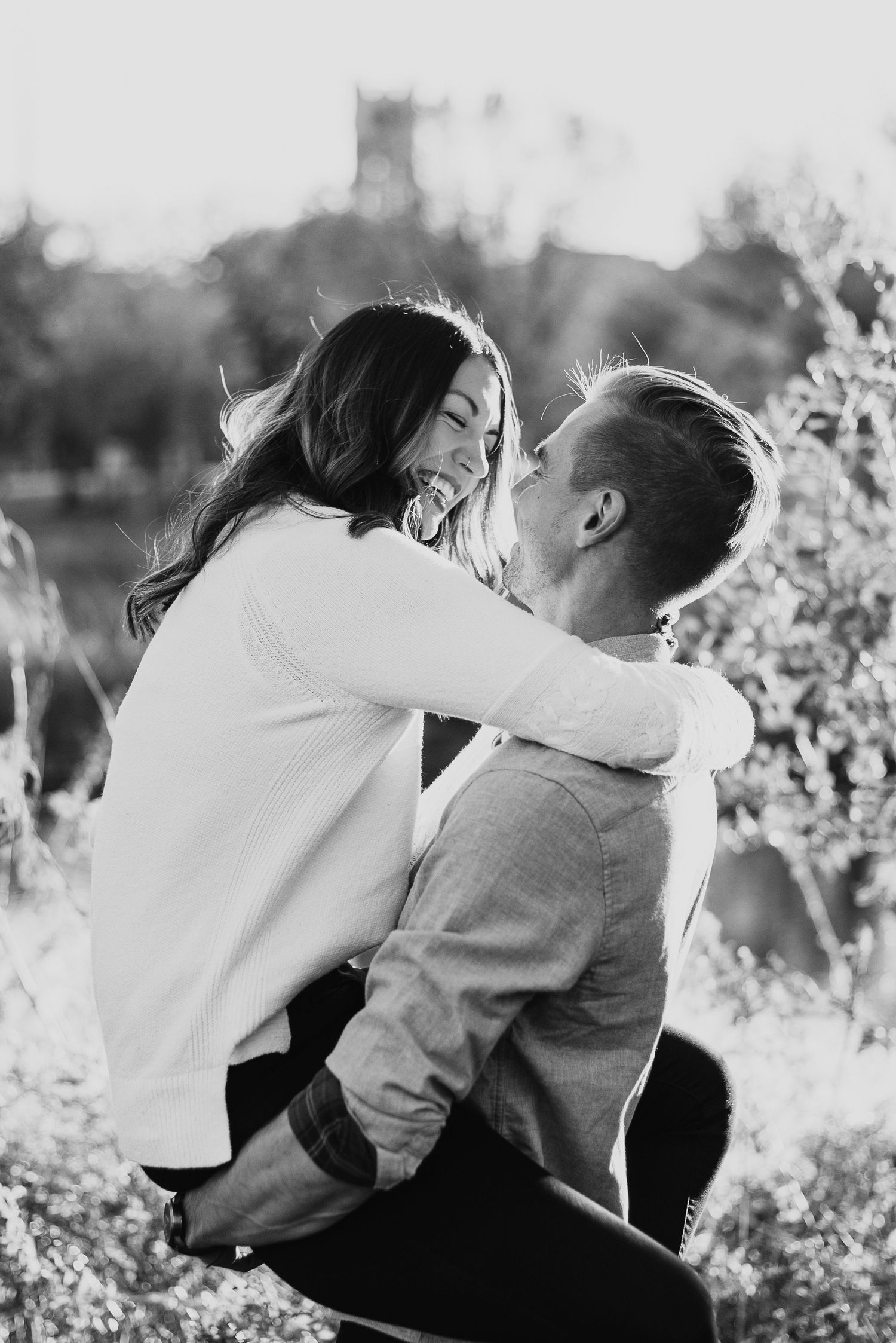 Engagement photo of a couple laughing and playing in Minneapolis in the Fall. Lindsay Miller Photography
