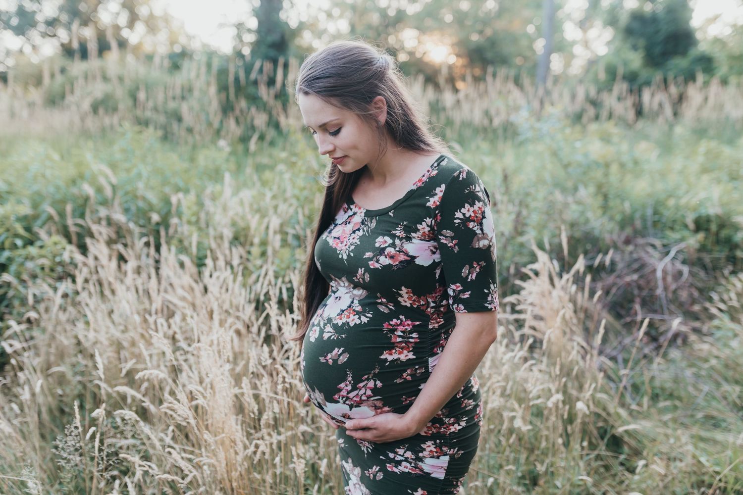 Pregnant woman looks down at belly at her maternity shoot in Lebanon PA