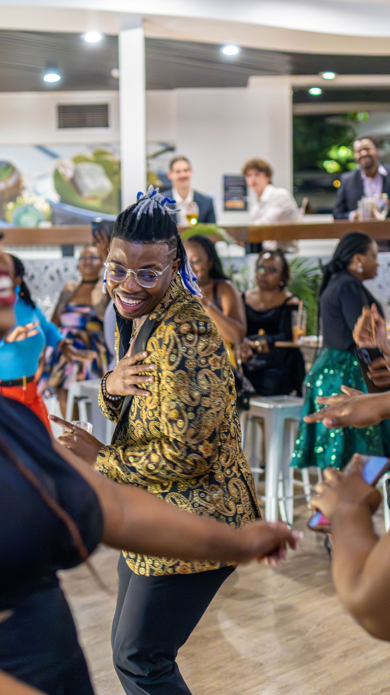Dancing and celebration at indoor party with people wearing festive attire.