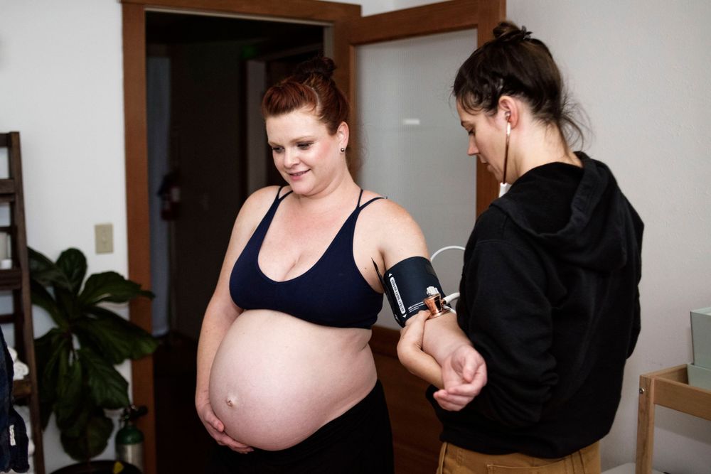 doula checking vitals on pregnant mama