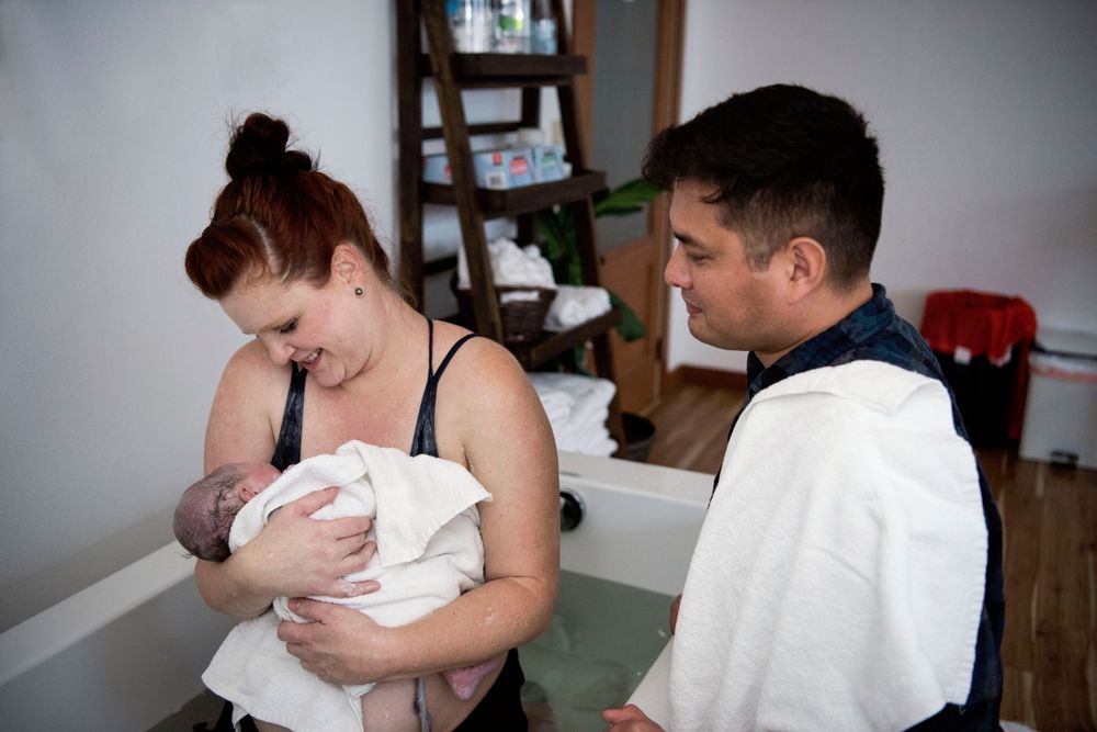 couple greeting their new baby for the first time