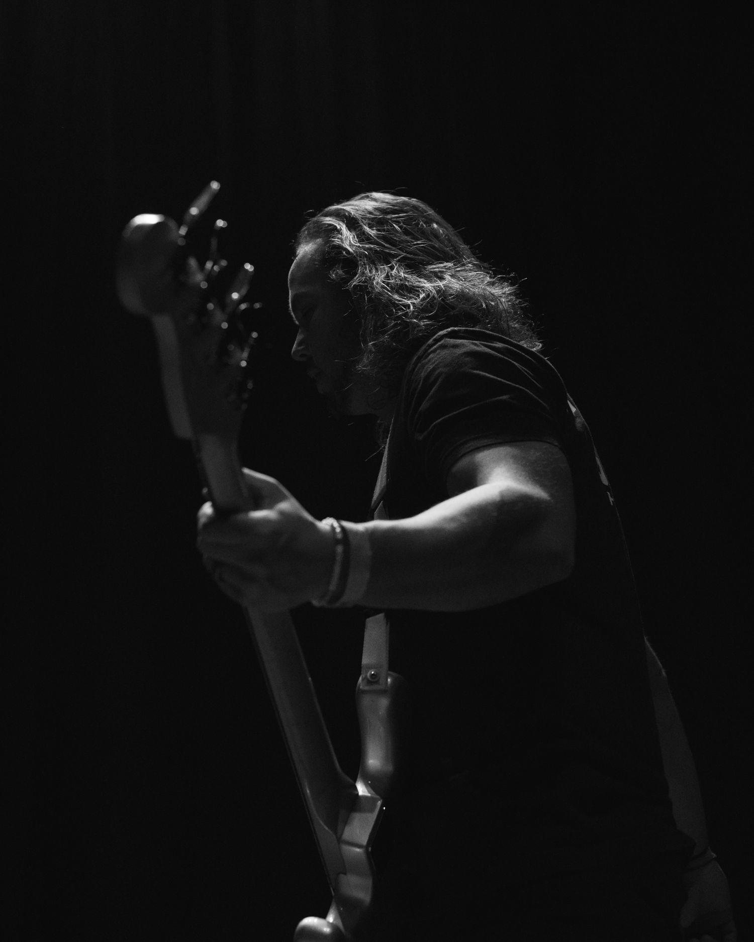 dramatic photograph band member playing guitar