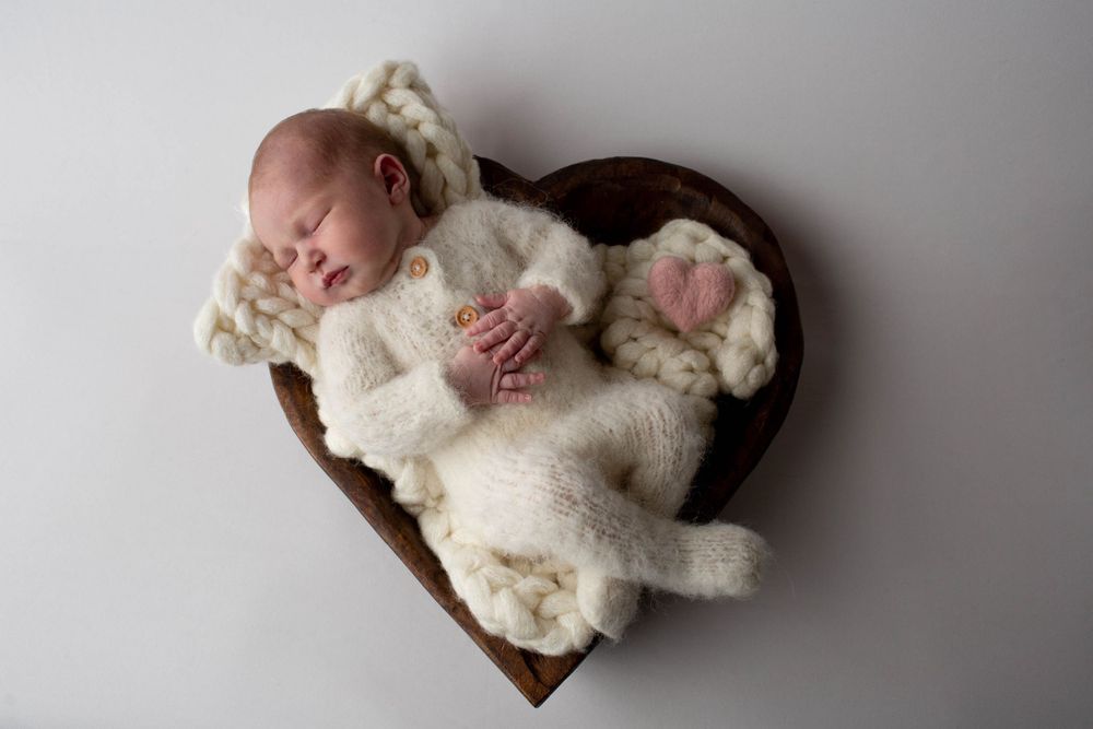 sleeping baby posing for photograph on heart in barrington, ri