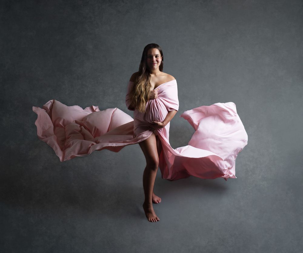beautiful pregnant woman in flowing pink dress in barrington ri