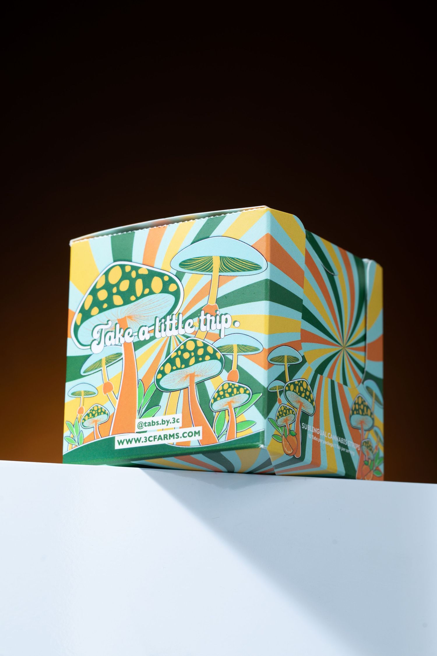 Colorful retro mushroom-themed 3C Farms packaging box with psychedelic swirl design.
