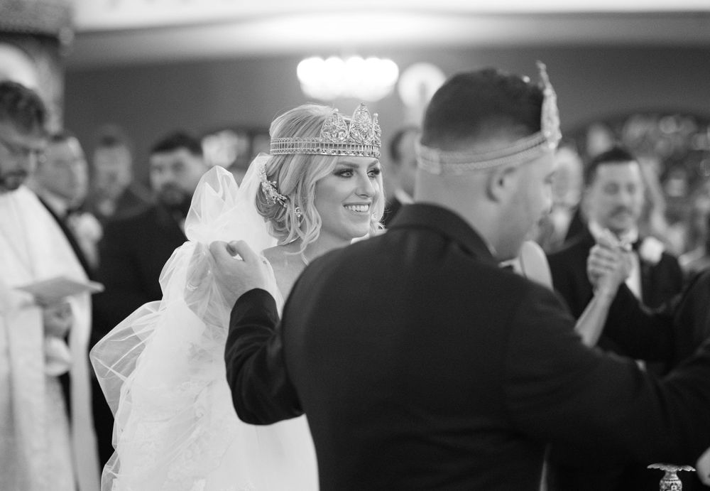 Black and white photo of newlyweds dancing at their wedding reception.