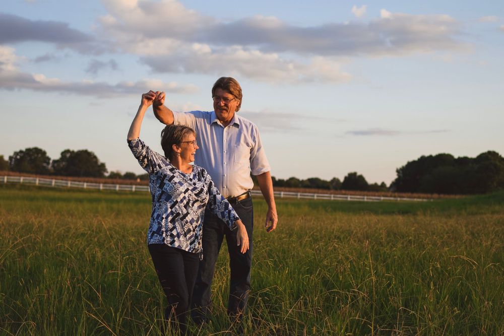 Group enjoying a sunset walk in an open field with golden light.