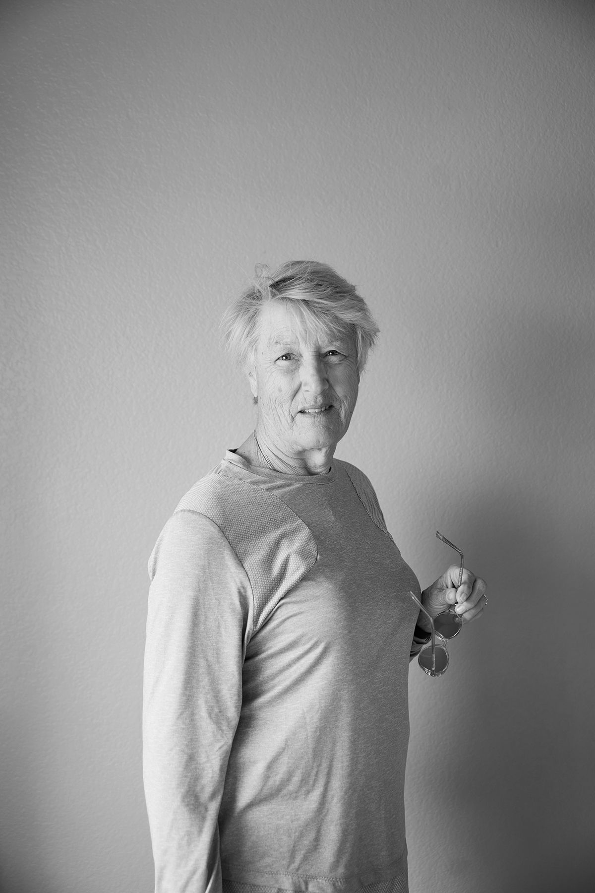 Black and white portrait sequence showing casual poses in light colored clothing.