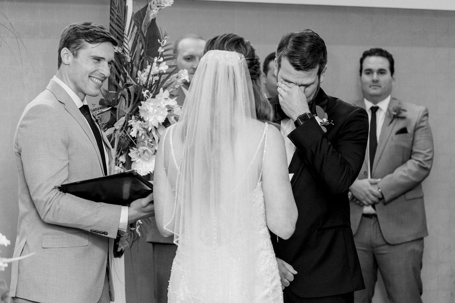 Groom crying while he hears brides's vows for him during the american style wedding ceremony