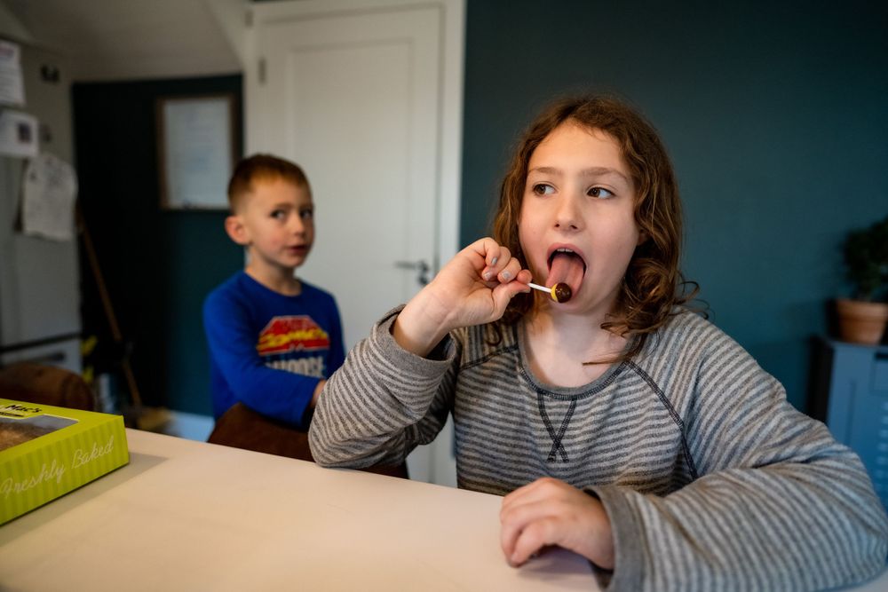 Children at a kitchen table during snack or meal time.