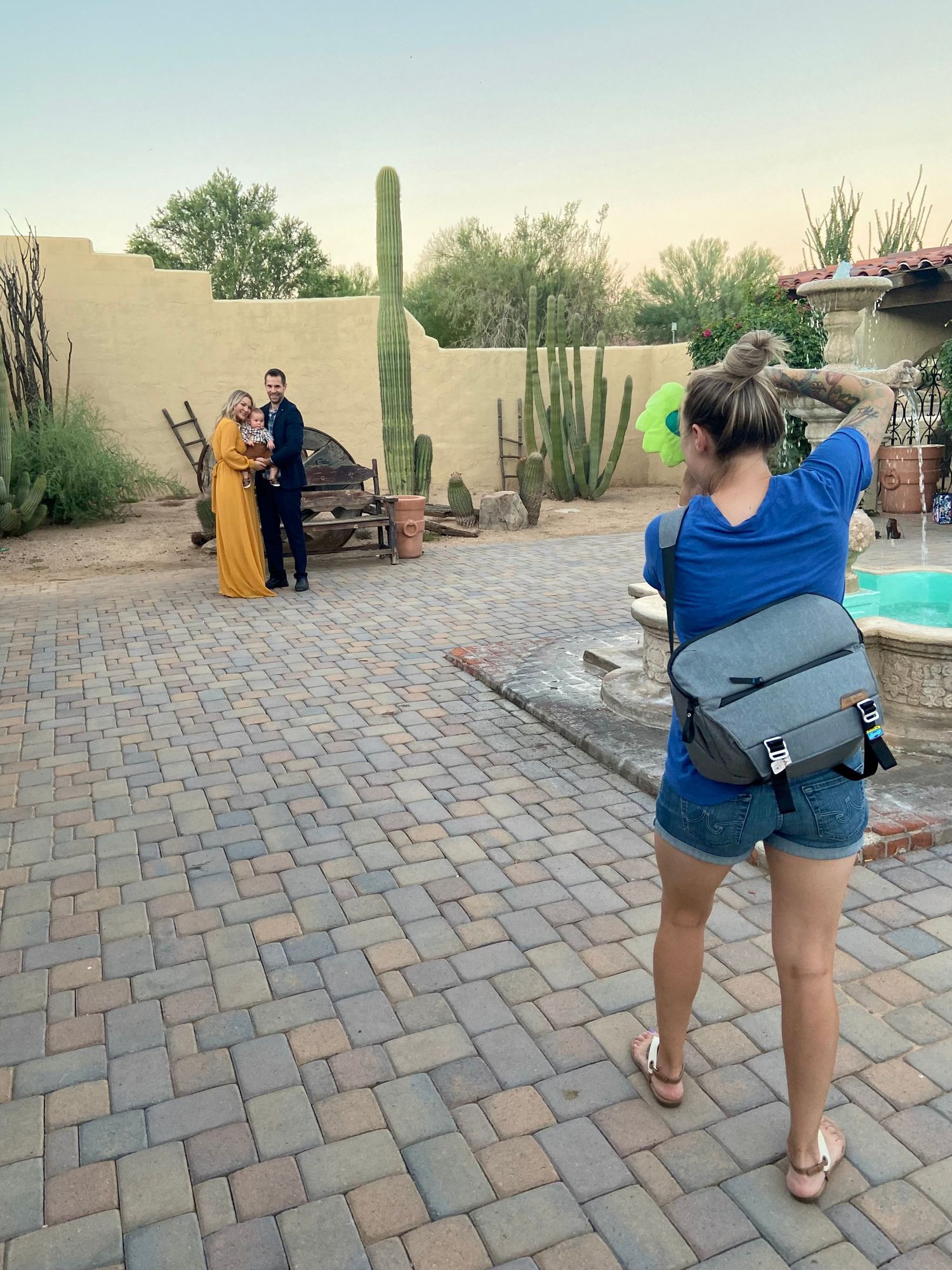 Desert wedding photography scene with large saguaro cactus and brick patio.