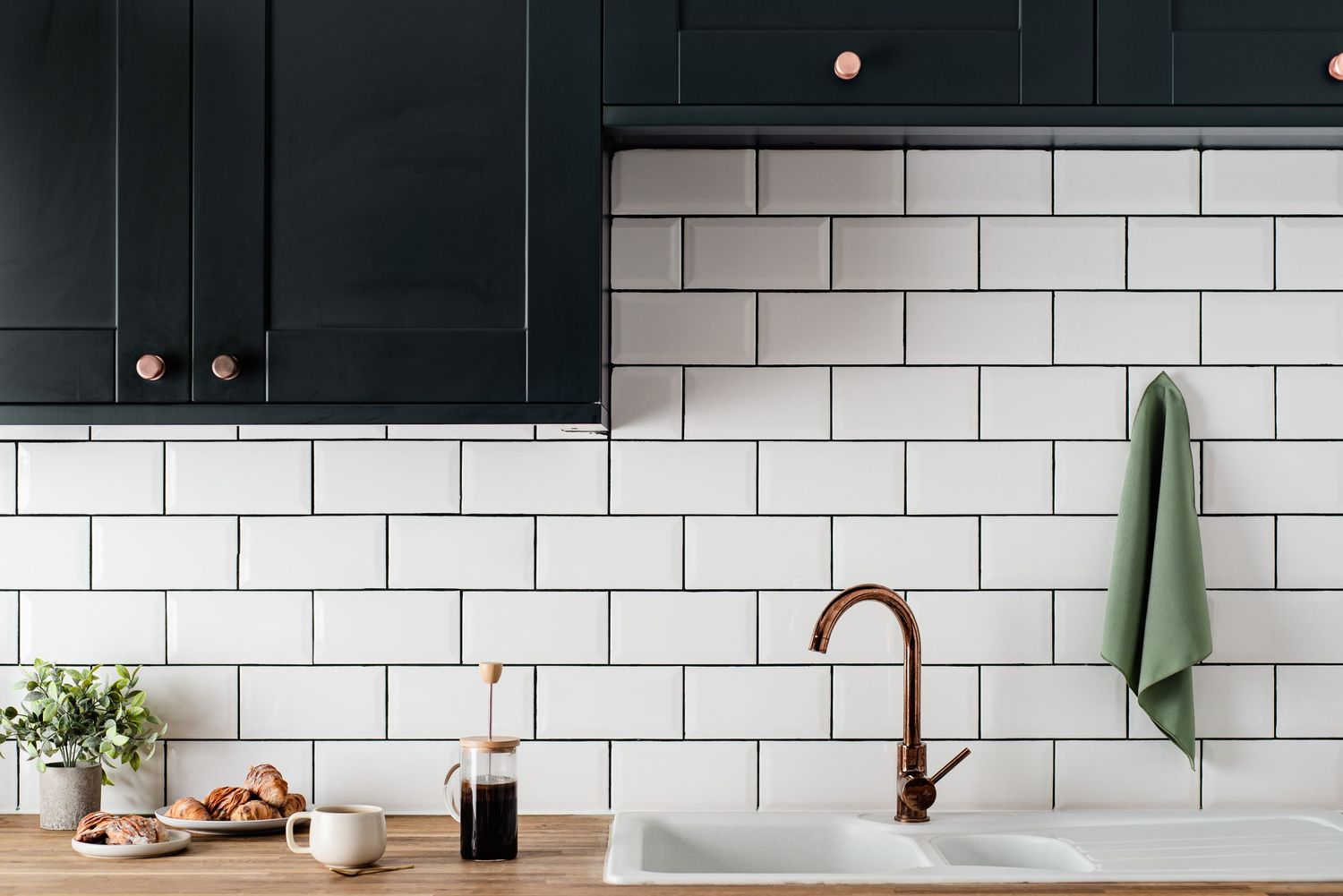 stylish blue kitchen with white walls, coffee and pastries on counted. inviting holiday let photography