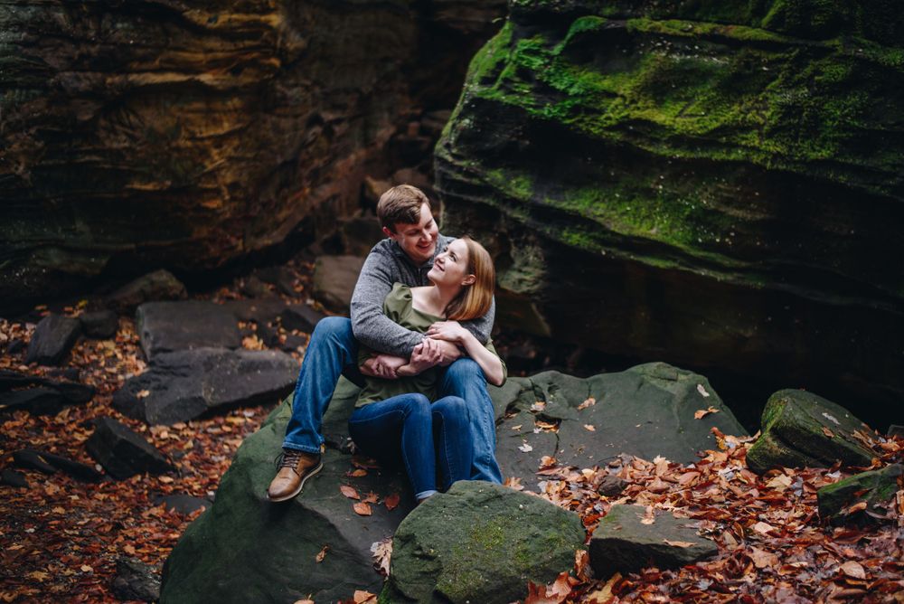 Couples poses on rock in Cuyahoga Valley National Park Ohio Adventure session, Wedding and Engagement Photographers