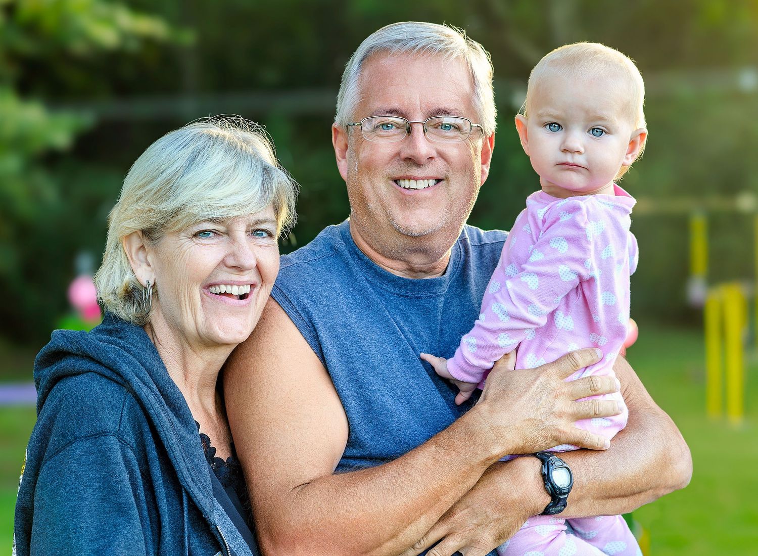 Chris Cleveland with his wife Linda and granddaughter, photographed outdoors in Mid-Missouri for a family legacy session.