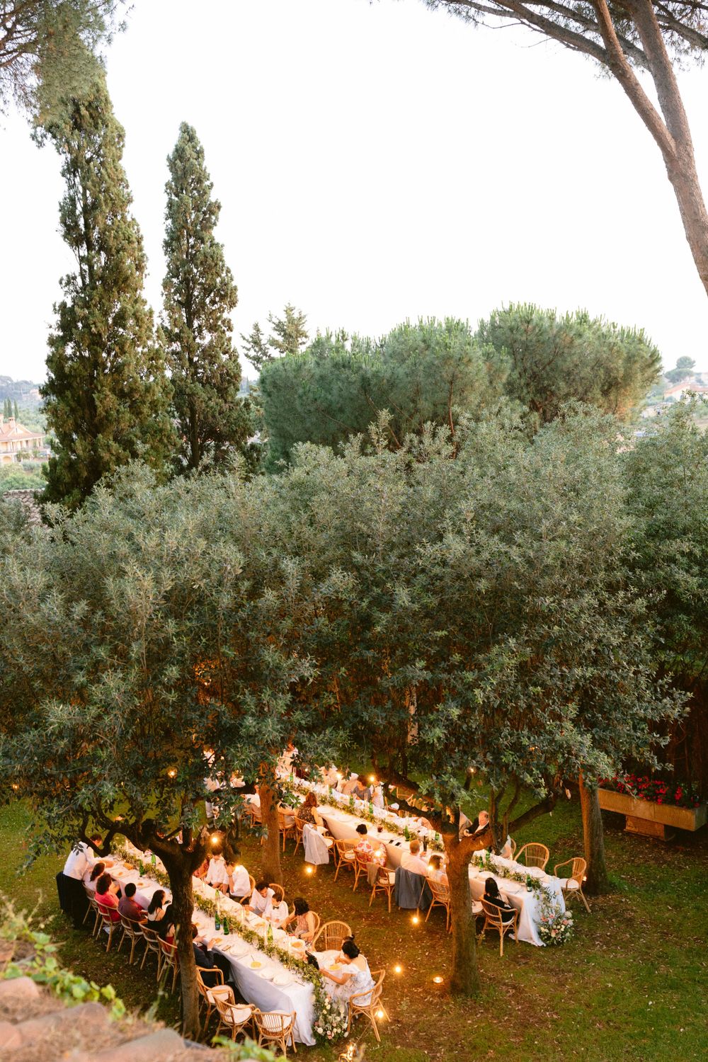 Enchanting outdoor reception illuminated by twinkling lights, creating a magical and romantic atmosphere