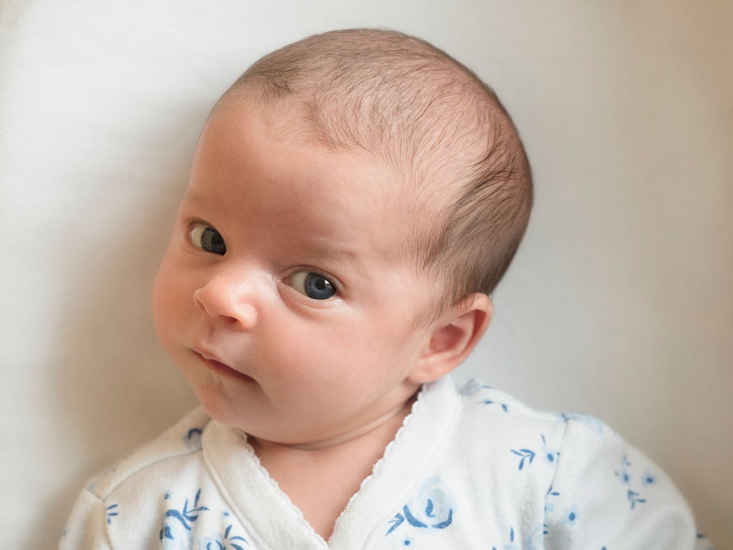 baby looking curiously up at camera