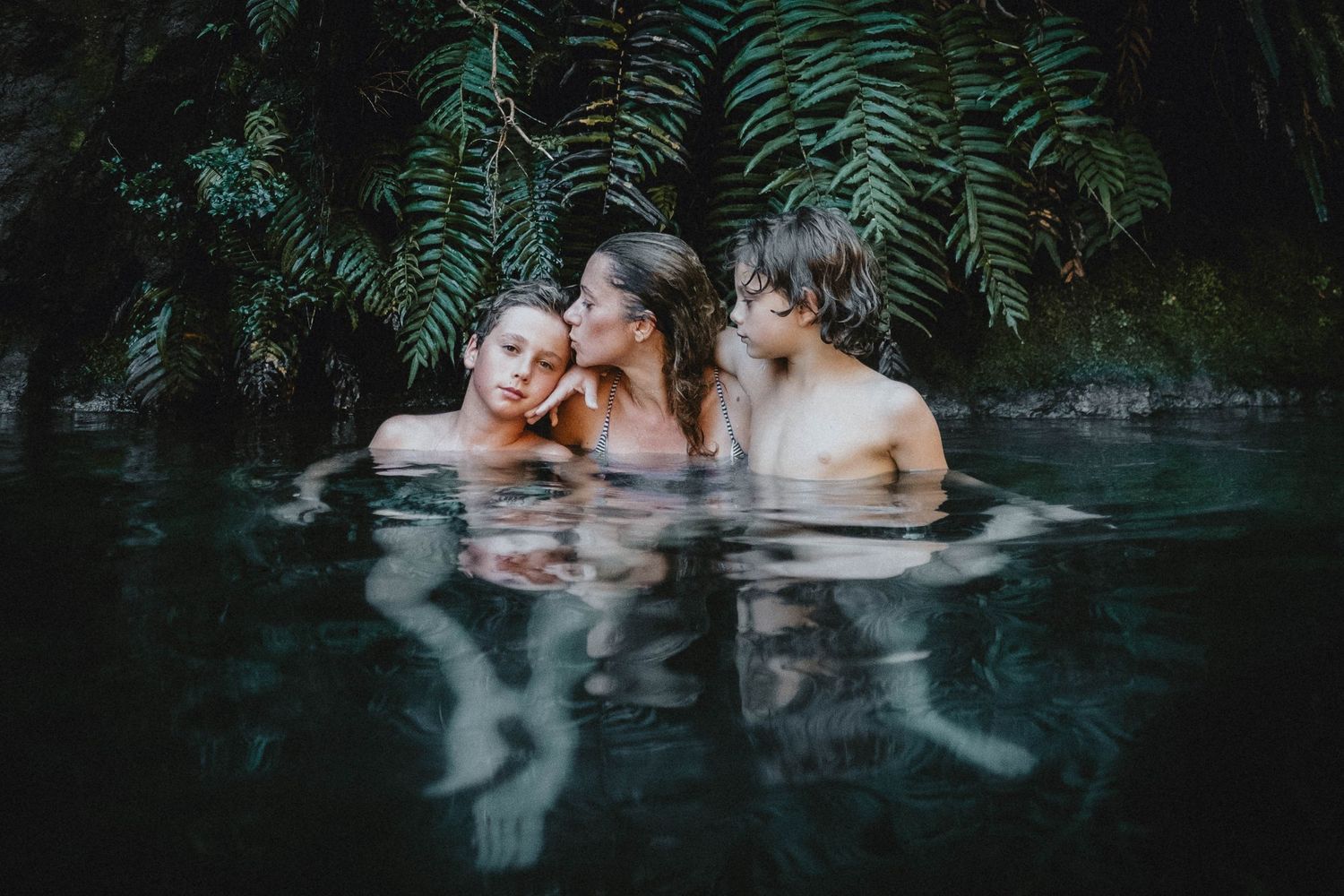 Mother and children enjoying a family moment at Las Termas Geométricas in Chile, capturing joyful, relaxing, and intimate experiences in nat