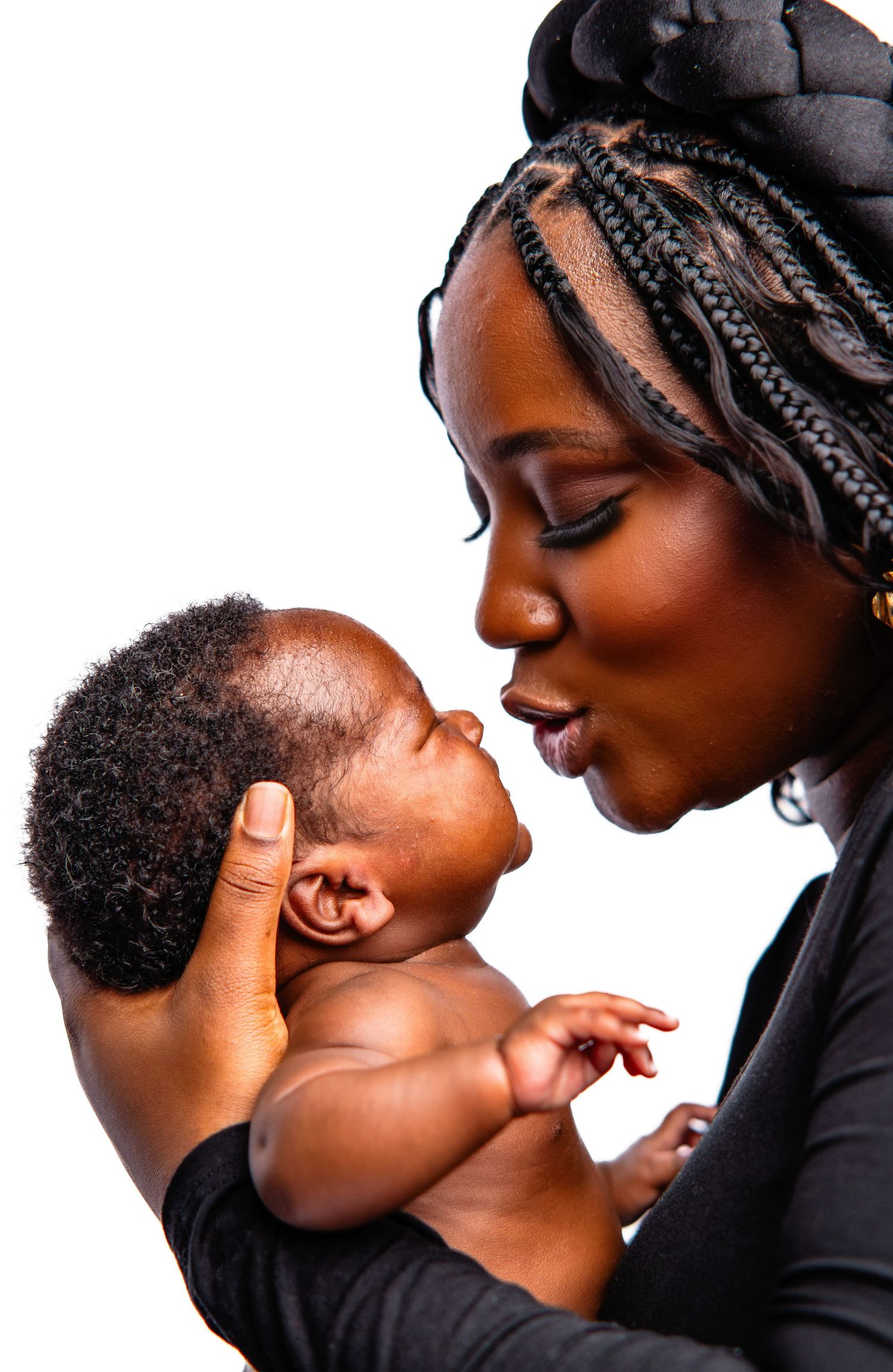 Intimate black and white portrait series of parent and baby against white background.