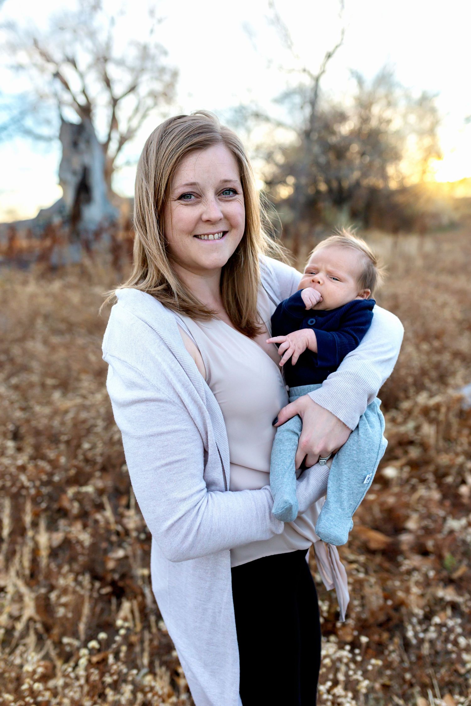 momma and baby outside in wheat colored field