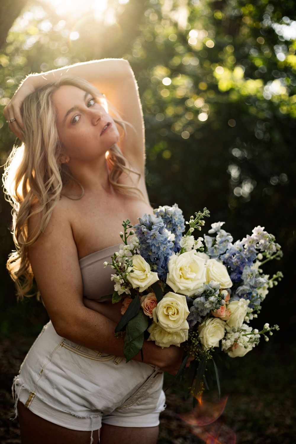 Golden hour portrait with an elegant arrangement of roses and hydrangeas.