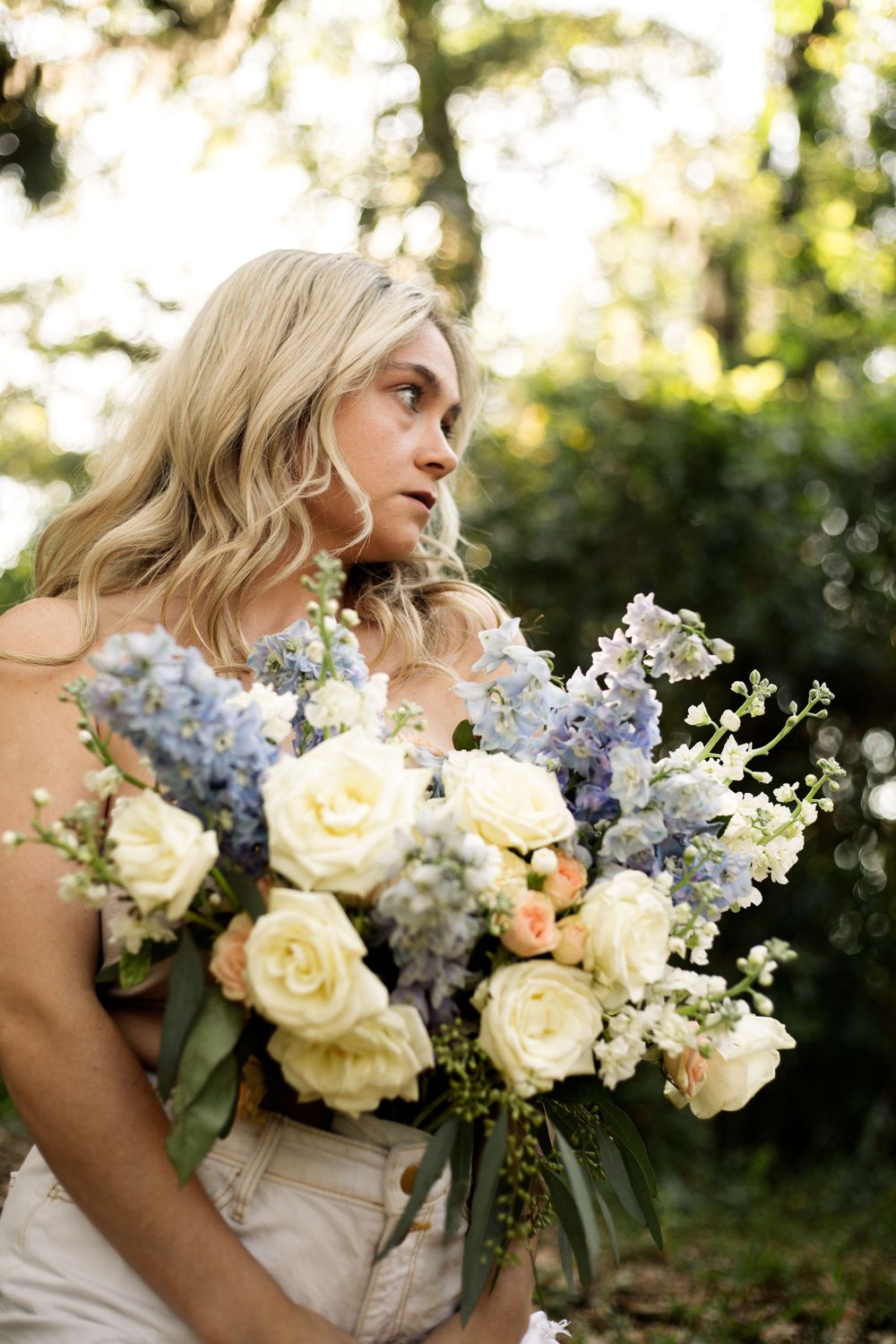 Artistic side profile shot with an elegant bouquet of mixed pastel flowers.